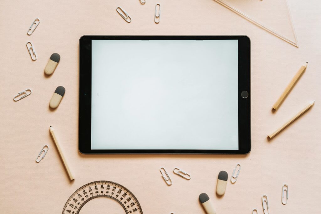 An ipad with paperclips and tablets