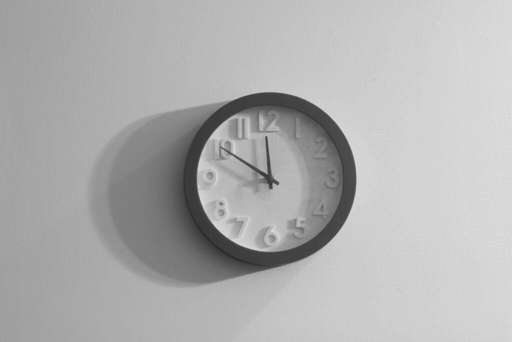 A white clock with shadow