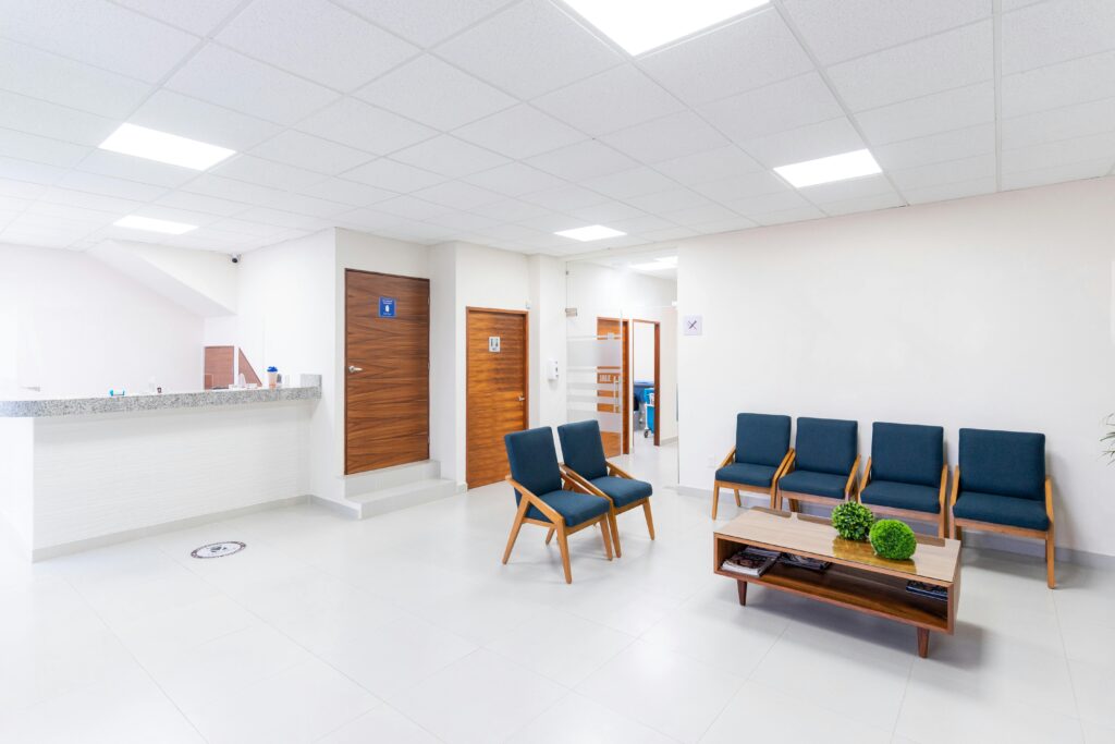 A hospital waiting room with 5 blue chairs